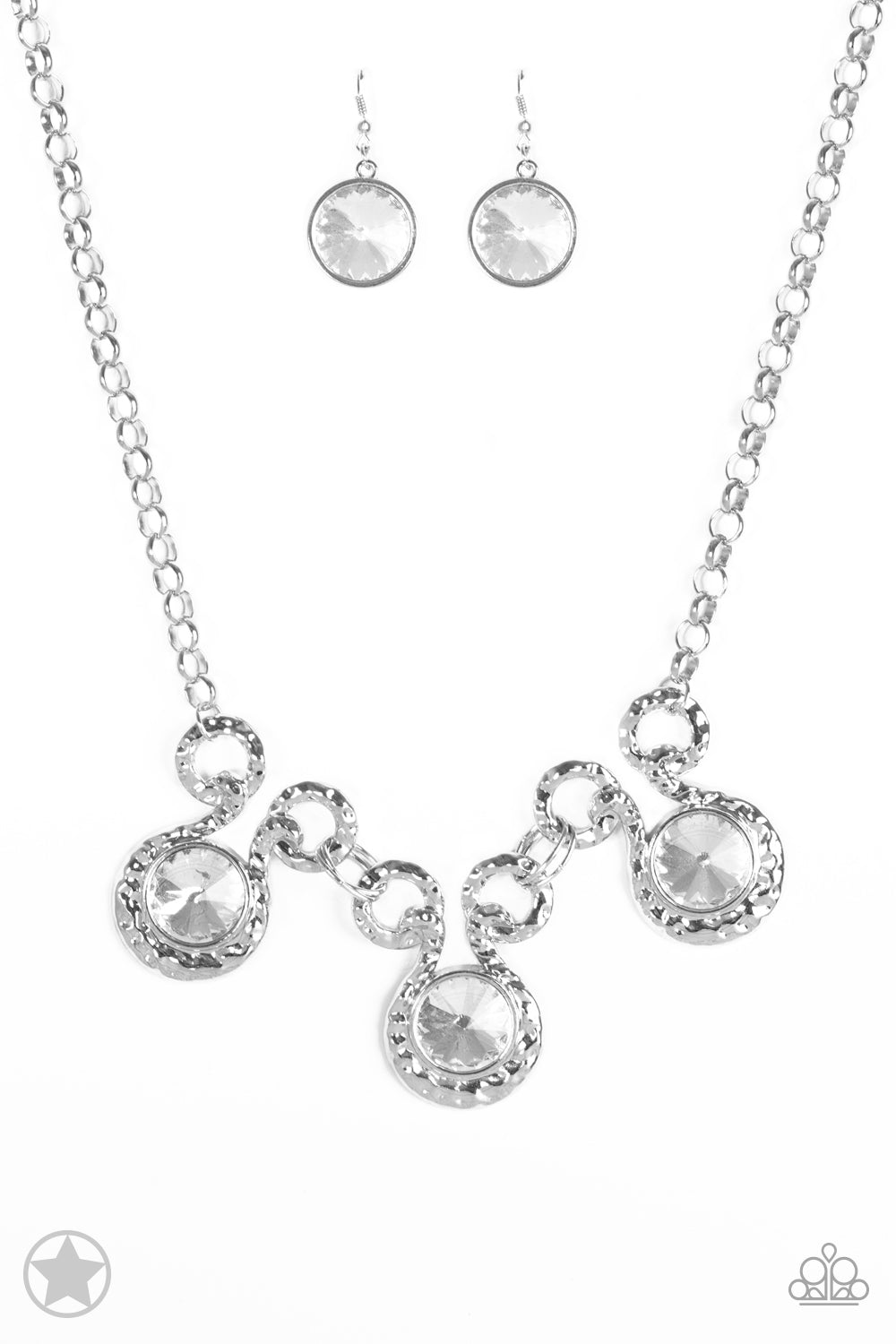 Three dramatically oversized rhinestones are nestled into three textured silver fittings that are connected by oval silver rings, creating a brilliant statement piece. Features an adjustable clasp closure.  Sold as one individual necklace. Includes one pair of matching earrings.